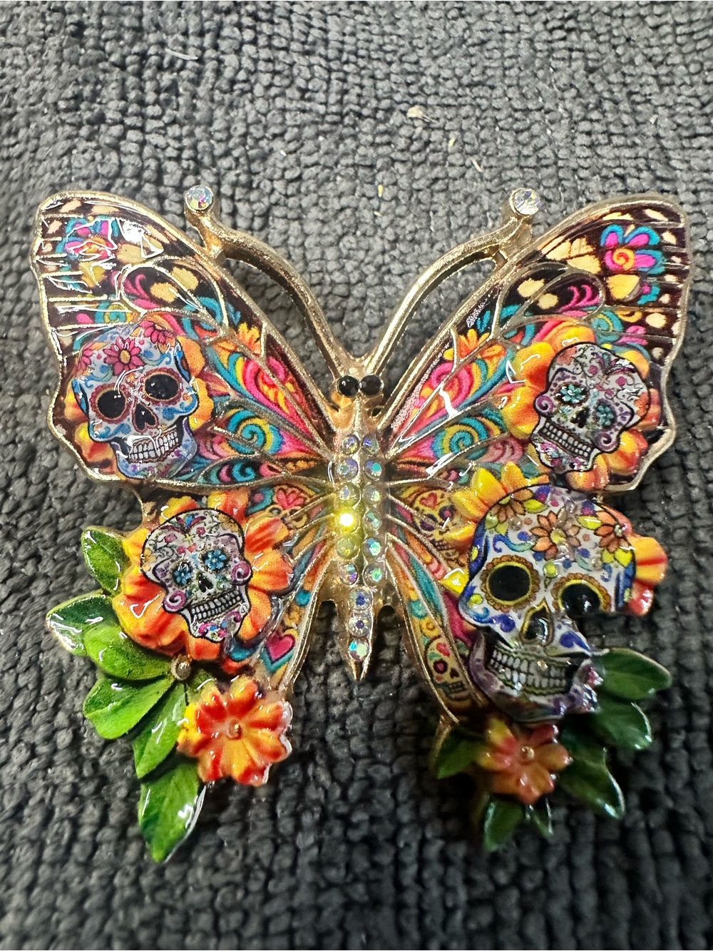 Butterfly brooch with sugar skulls